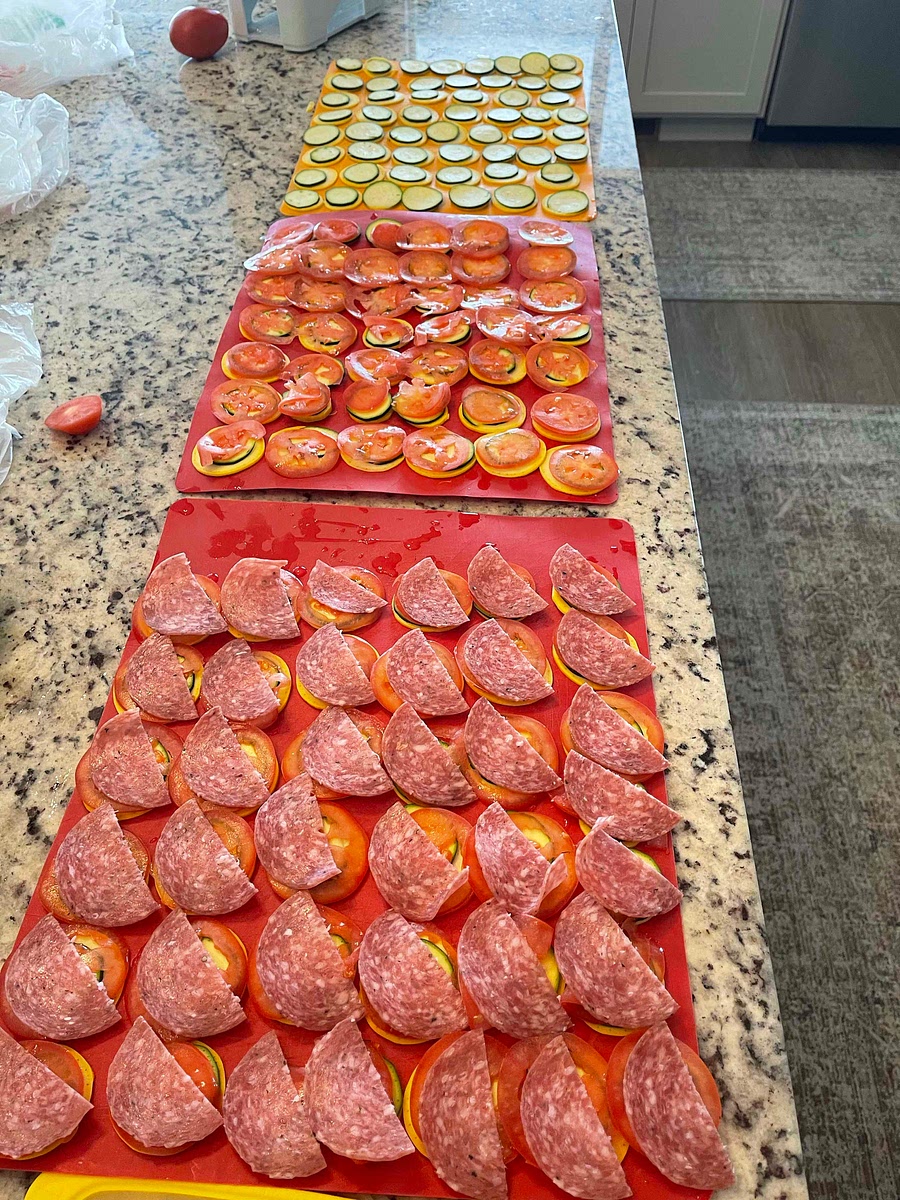 While that’s cooking slice your zucchini, yellow squash and Roma tomatoes. Stack them so they’re ready to lay the pan.