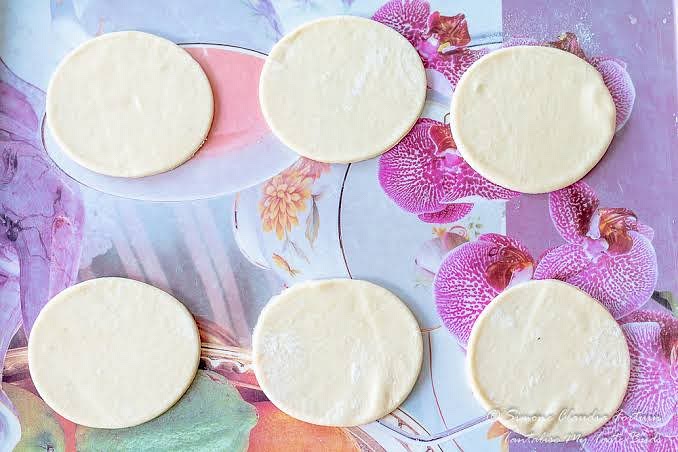 On a floured surface, roll out the dough and cut out circles with a large round cookie cutter.