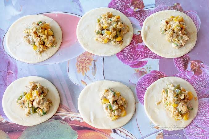 Spoon the filling onto the centre of the circles. Brush the edges with water.