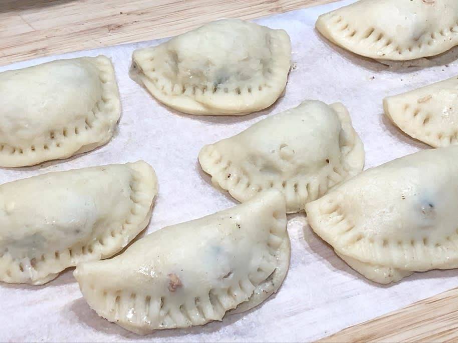 Fold over to make a half-moon and press the edges closed with a fork.