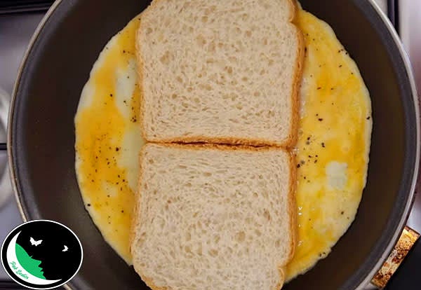 Method:
Take a bowl and beat eggs.
Heat up oil in a medium sized pan.
Pour beaten eggs. Sprinkle salt and pepper.
Place 2 pieces of bread onto the egg mixture. Allow to cook for 1 minute.
Flip the whole egg-bread toast, without breaking it.
Fold egg sides of the bread.
Then place cheese and potato culet on one slice of bread.
Then fold one slice of bread over the second slice.
Cook the sandwich for 1 more minute.
Serve!