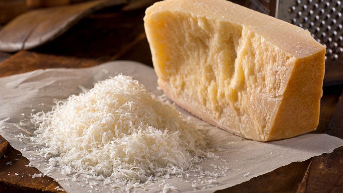 Gradually add the grated cheese while mixing, ensuring it is fully incorporated into the dough.