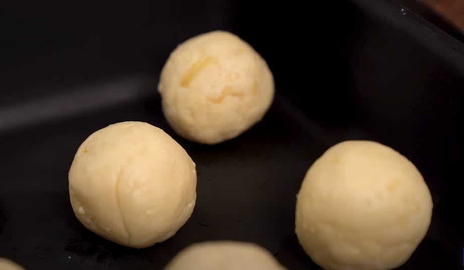 The dough is very sticky; to roll it into ping-pong ball-sized portions, grease your hands with oil or water.