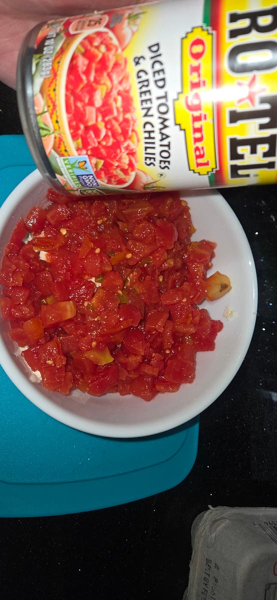 Add 1 can of rotel including the juice, mix gently to help tofu absorb some of the juice from the rotel tomatoes. Set aside.