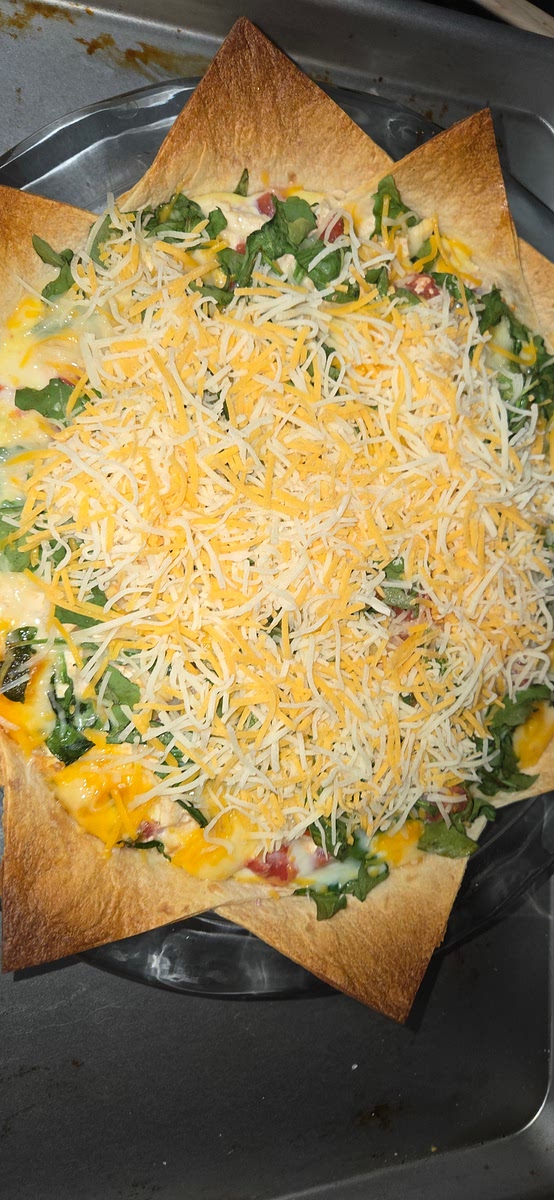 Take out, add shredded cheese. Place back in oven for 15-20 minutes until the cheese melts and the eggs are fully set. It should puff up a little but not be jiggly.