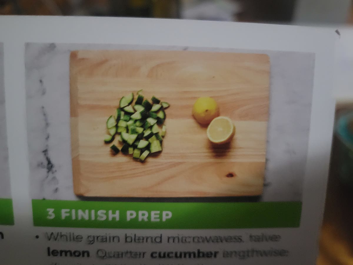 While, grain blend microwaves, halve lemon. Quarter cucumber lengthwise slice into 1/4 inch thick pieces.