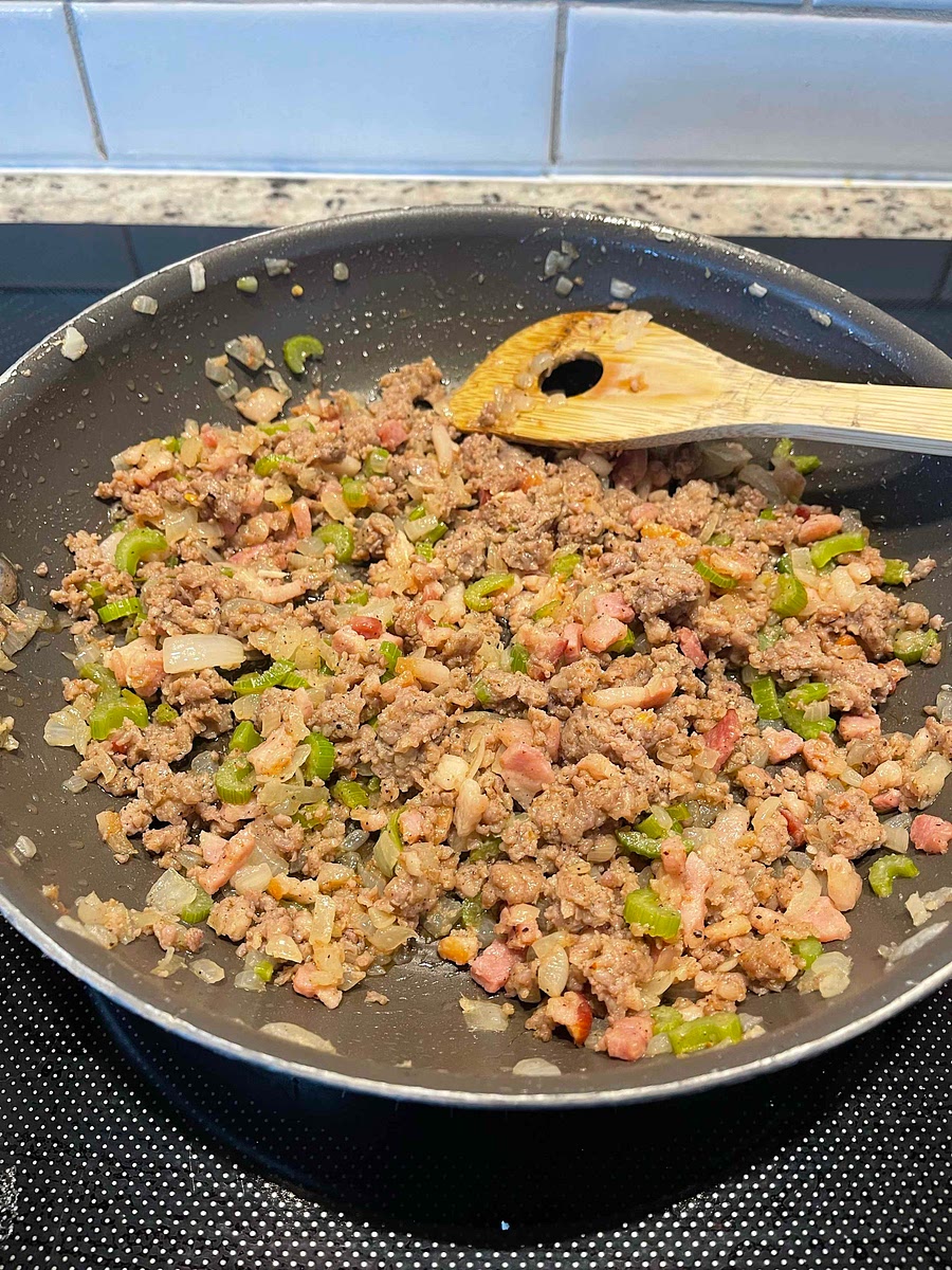 Add the ground pork. Break up the meat with the back of a fork. Season with nutmeg and a few grinds of black pepper. Cook until the pork loses its pink color and most of the liquid has evaporated, about 3 minutes. Discard the rosemary sprig.