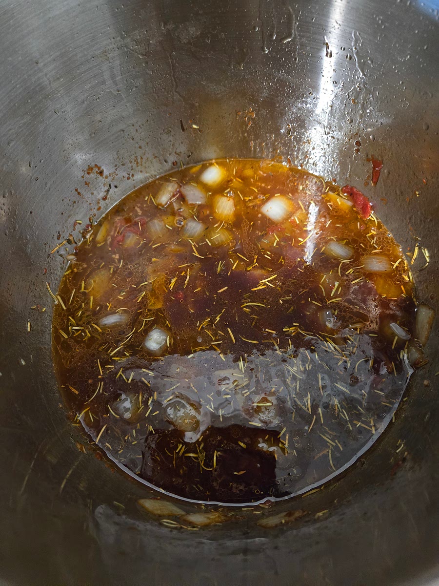 Pour in the beef broth and wine combo.