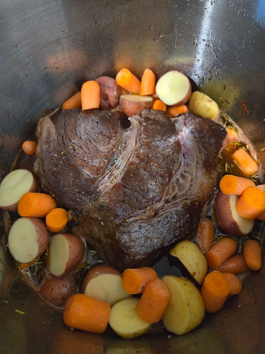 Arrange the little potatoes and carrots around the roast.