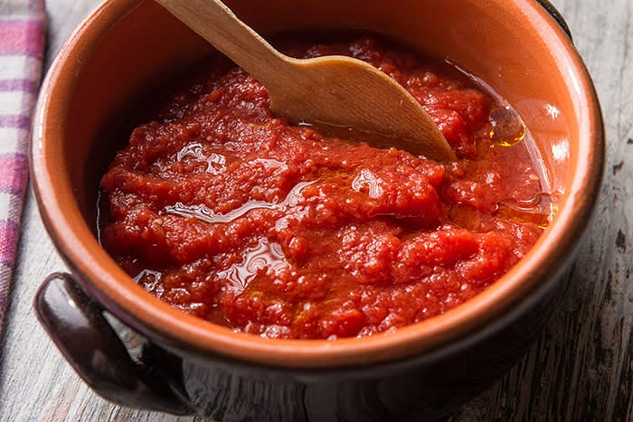 Aggiungi la passata di pomodoro e lascia cuocere coprendo a metà col coperchio.