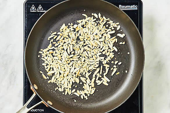 Toast the almonds - Meanwhile, put the almonds in a cold large deep frypan over medium heat. Toast, tossing, for 3-4 mins until evenly golden.