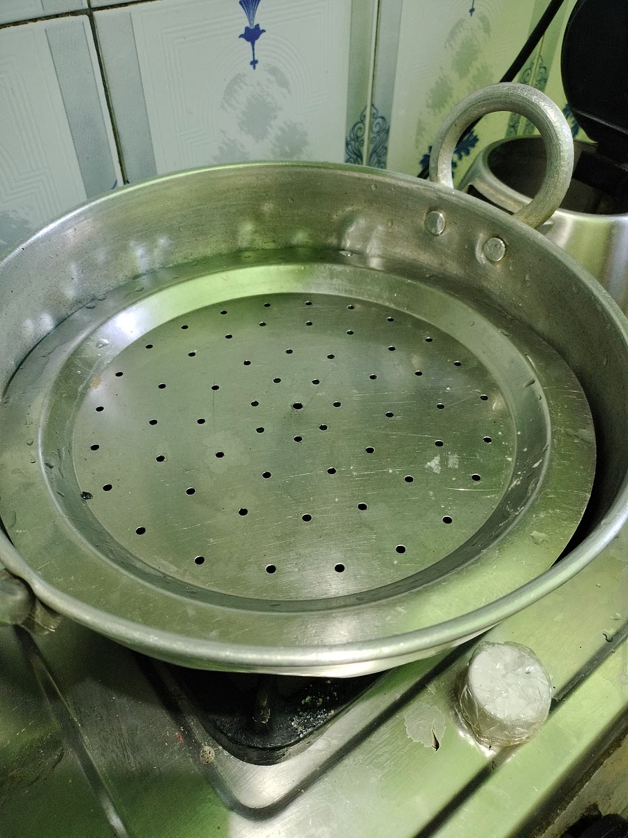 if you don't have idli cookware set, in a kadhai, add 2½ cup of water and close it with the shown type of utensil.