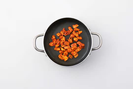 Add the gochujang to the meat, turn to coat the chicken and fry until fragrant, 1 min.