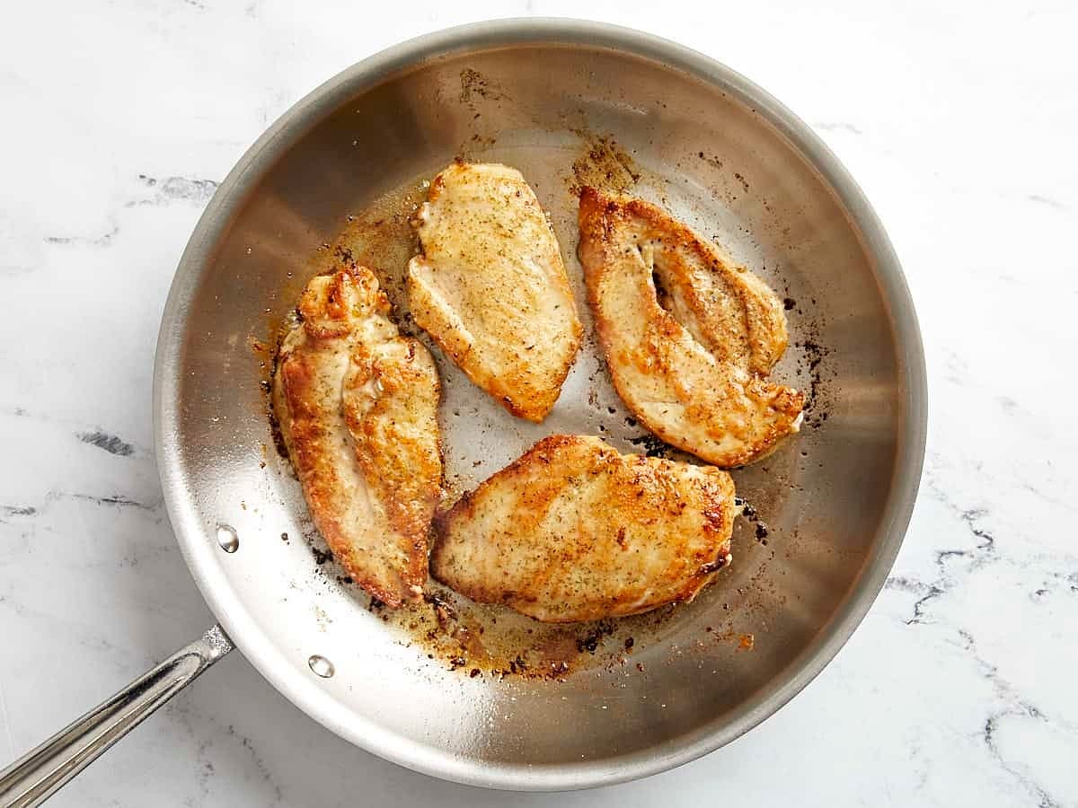 Heat a large skillet over medium heat and add 2 Tbsp olive oil and 1 Tbsp of butter. Once the skillet is hot, add the chicken and cook on each side until golden brown and cooked through (about 4 minutes per side). Remove the cooked chicken to a clean plate and cover to keep warm.