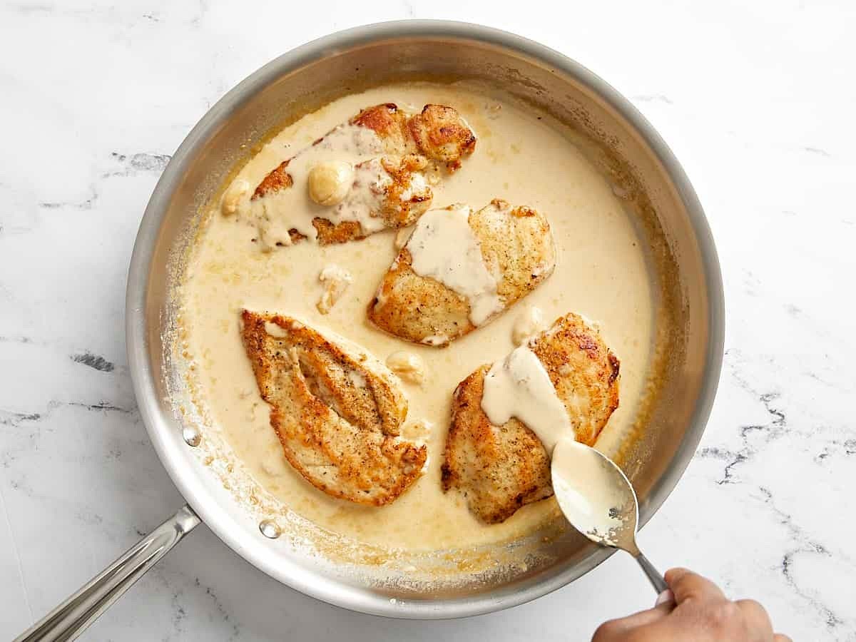 Taste the sauce at this point and add salt and pepper if needed (I added about ⅛ tsp of salt and ⅛ tsp of black pepper). Return the cooked chicken breasts to the skillet and spoon the creamy sauce over top. Allow the chicken to heat through.