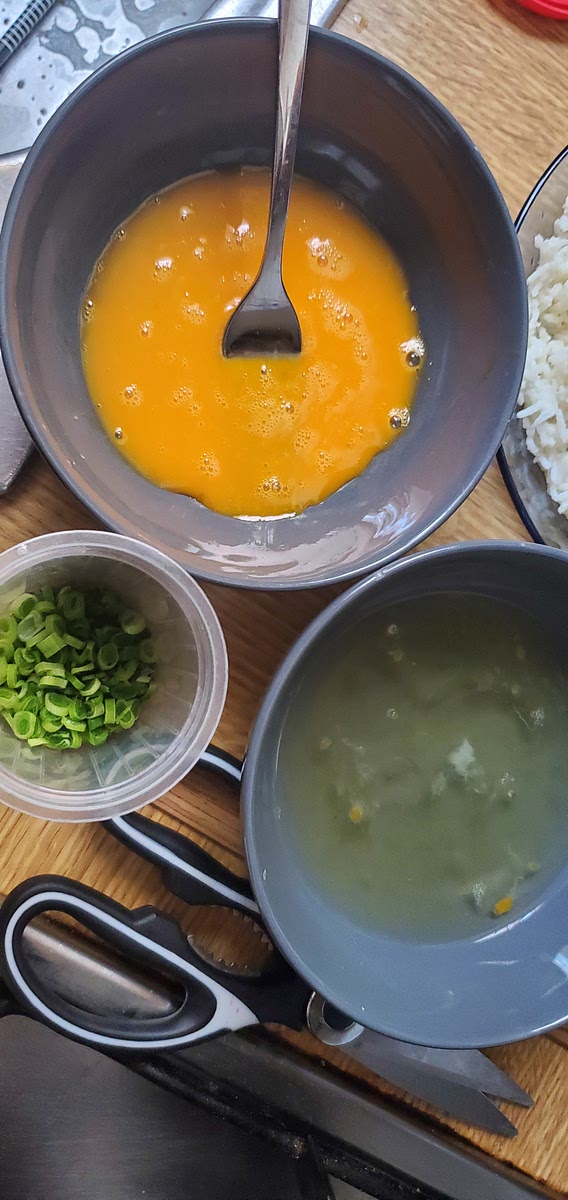 Cortar el kion, cebollita china (3 tallos) y separar la yema de la clara en dos tazones. La yema dale una removida. La parte blanca de la cebolla china lo dejas en tallo para ponerlo en la sopa a hervir.