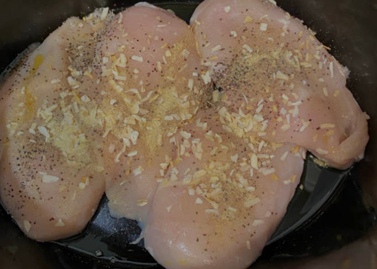 Put chicken in crockpot and cook with seasonings and onions
