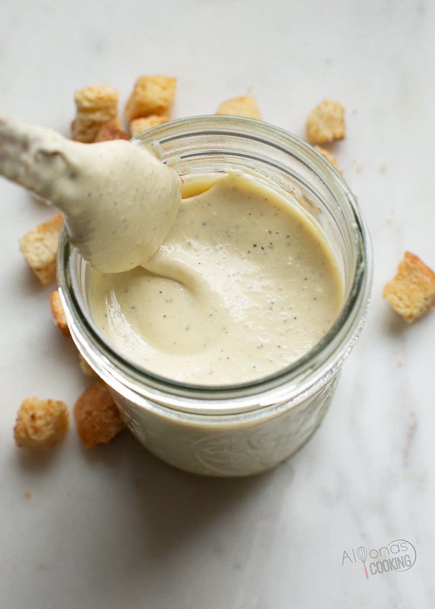 Prepare the dressing – In a small bowl, whisk together Greek yogurt, mayo, olive oil, lemon juice, mustard, minced garlic, Parmesan, salt, and pepper. Adjust seasoning if needed.