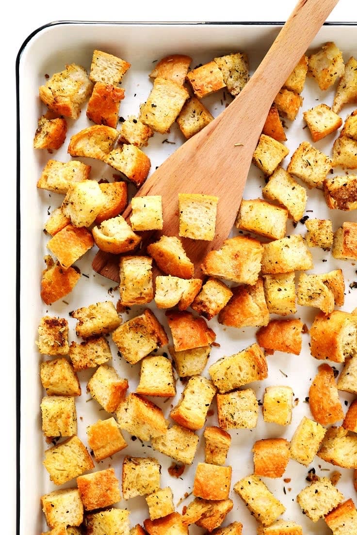 Preheat your air fryer to 375°F (190°C). Cube the whole grain bread into bite-sized pieces. In a large mixing bowl, toss the bread cubes with olive oil, garlic powder, salt, and pepper until evenly coated. Place the bread cubes in the air fryer basket in a single layer. Air fry for about 5-6 minutes, shaking the basket halfway through, until the croutons are golden and crispy. Set aside to cool.