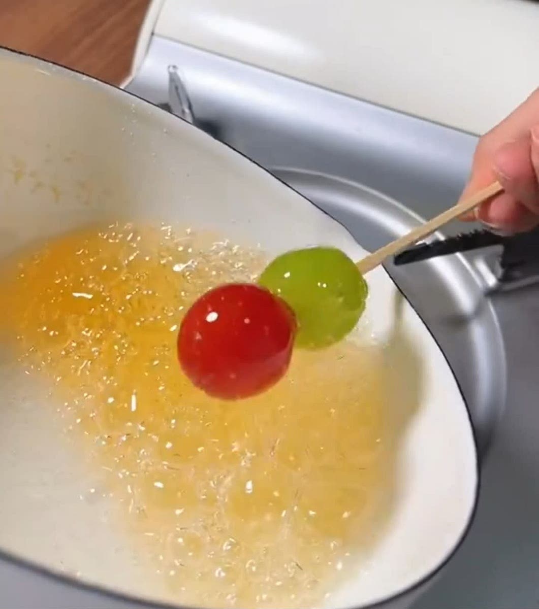 Dip the fruit skewer into the sugar mixture and gently turn it to coat all of the sides