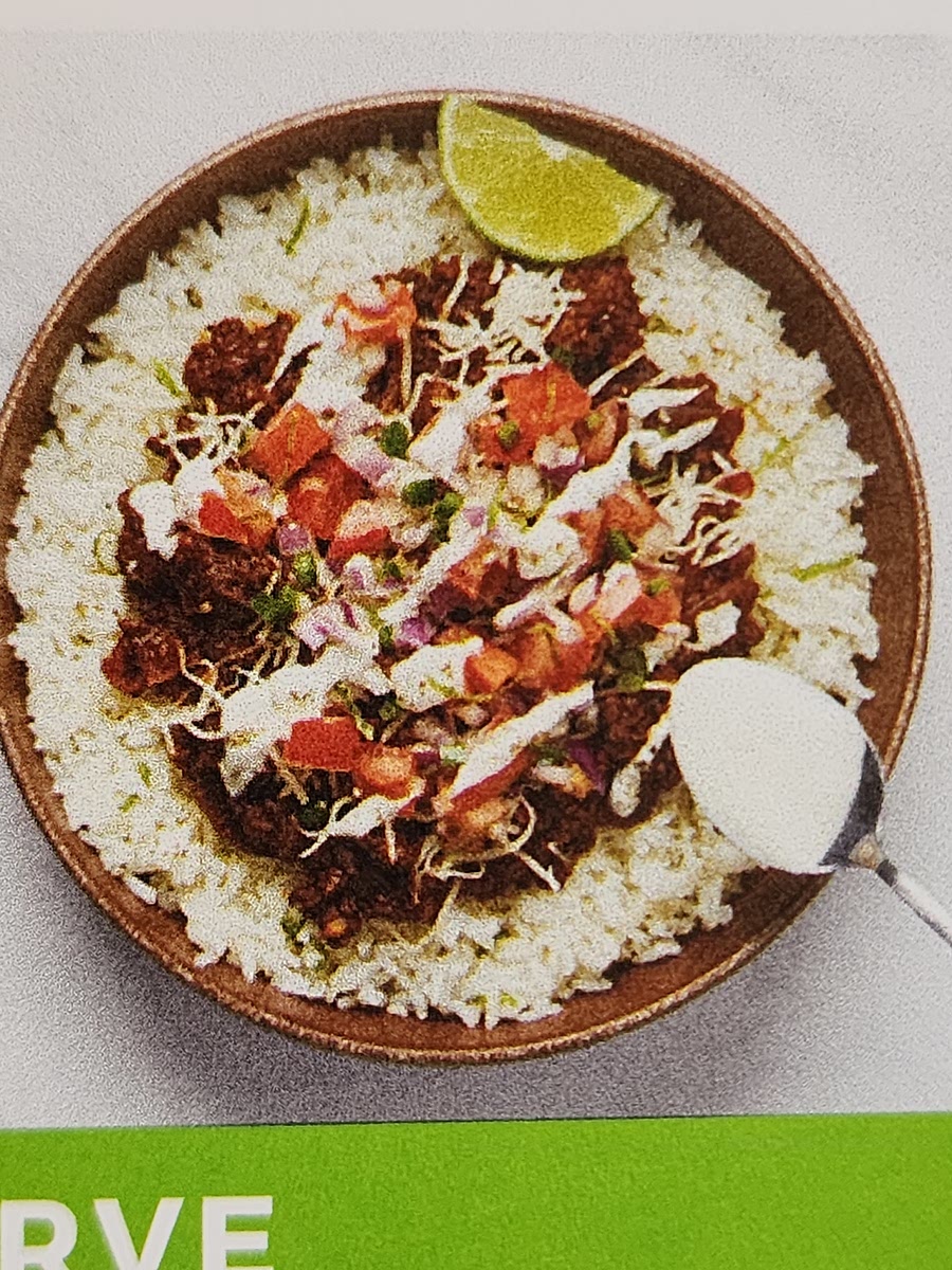 Divide rice between bowls. Top with protein mixture, cheese, salsa, and crema. Serve with tortilla chips and remaining lime wedges.
