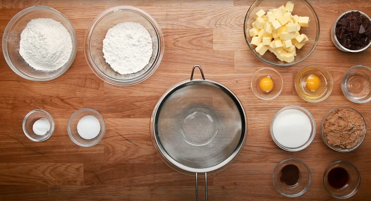 Preheat oven to 350F (180C). In a large bowl, sift together the bread flour, all-purpose flour, salt, and baking soda.