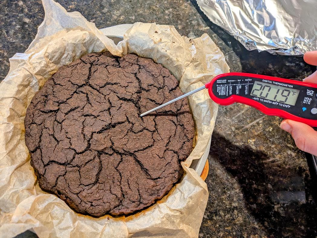 Bake at 350F for 30 minutes, uncovered. Cover with foil, and bake an additional 30 minutes. The cake should be set on the top, a toothpick should come out with some wet crumbs, and the internal temperature will be at least 200F