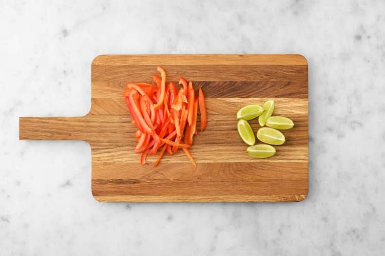 Boil a full kettle. Pour it into a saucepan with 1/2 tsp salt on high heat. Slice the pepper into strips. Cut the lime into wedges.