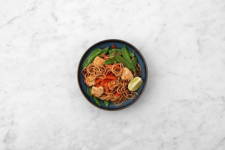 Share the noodles between your bowls. Serve with a lime wedge on the side for squeezing over.