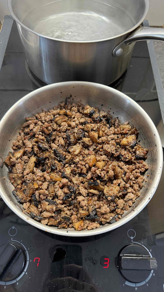 Une fois la chair à saucisse colorée, baisser légèrement le feu et ajouter les champignons dans la poêle.
Saler, poivrer et couvrir d’un couvercle.
Laisser cuire pendant un moment (5-10min). Les mettre de côté.