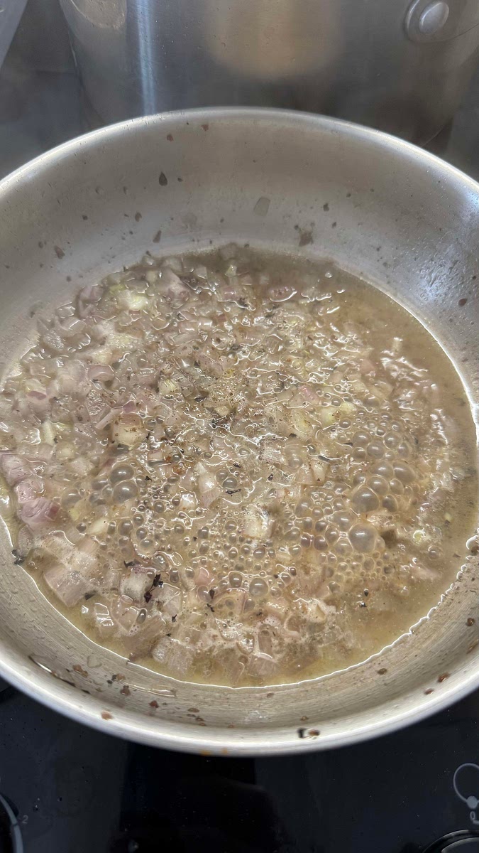 Déglacer la poêle avec du beurre, les échalotes émincées, l’ail et le vin blanc.