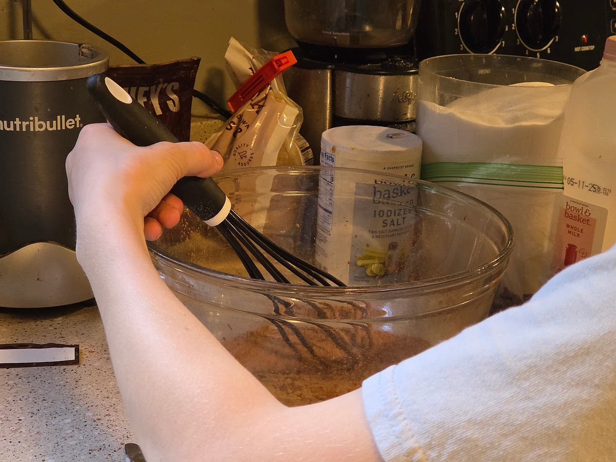 In a large bowl, whisk together the cocoa, sugars and salt.