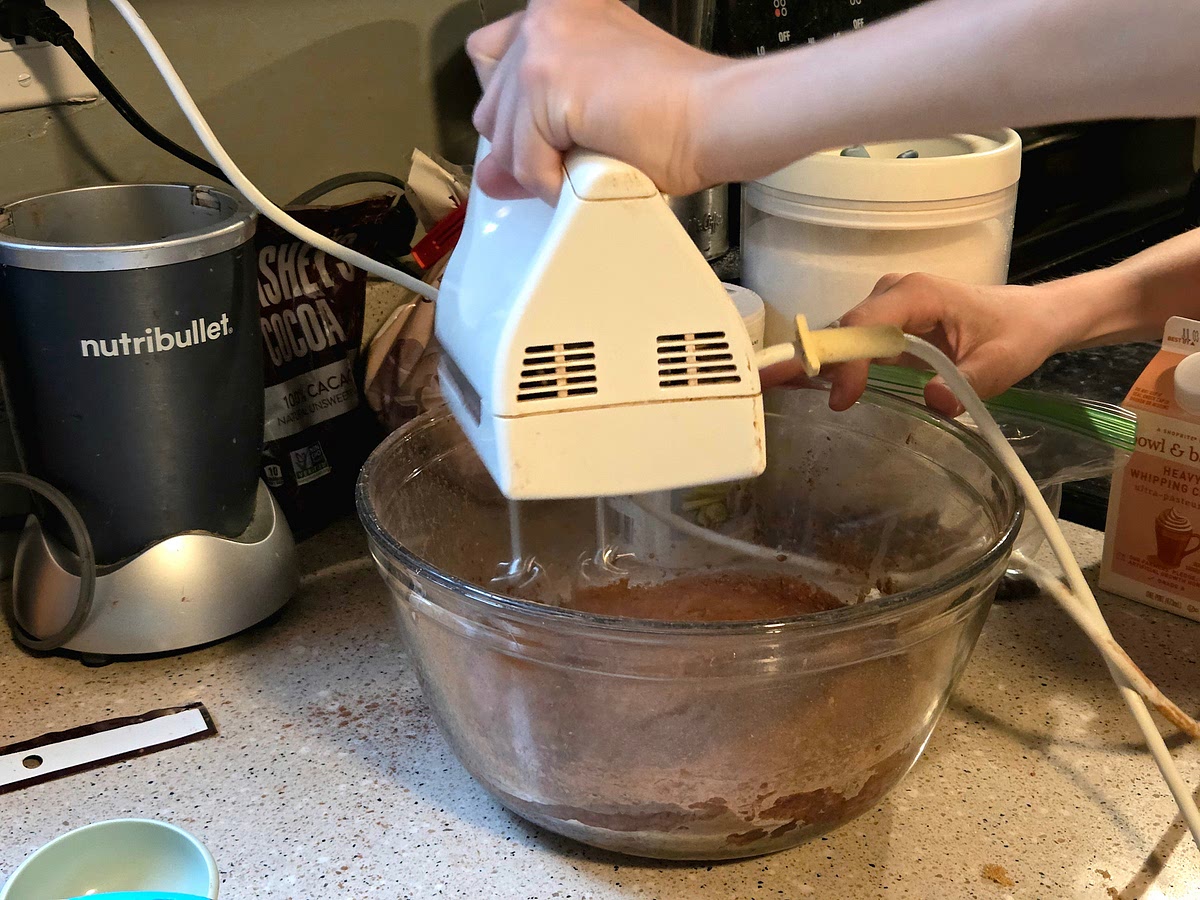 Add the milk and, using a hand mixer on low speed, beat to combine until the cocoa and sugars are dissolved.