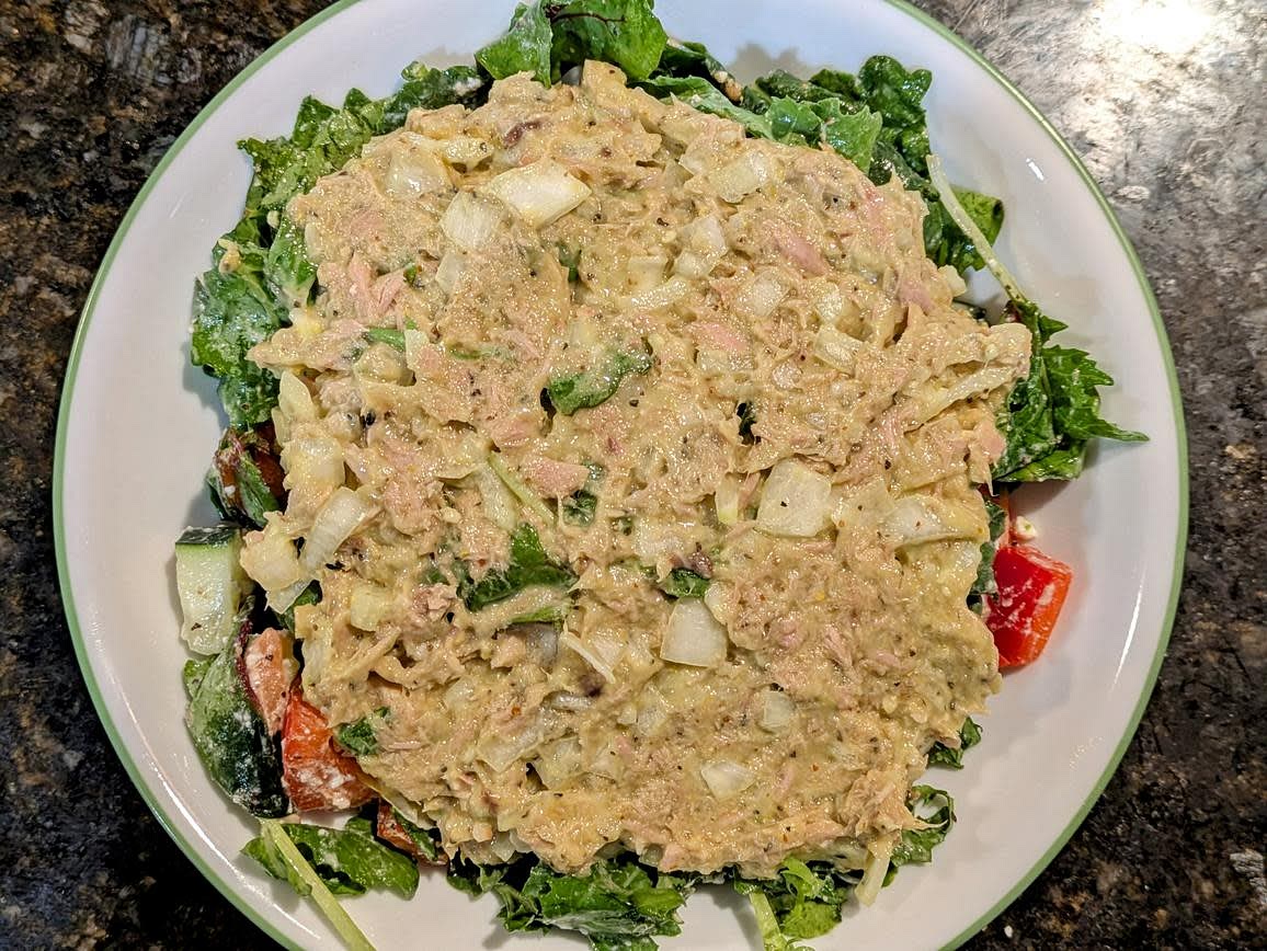Cut your onion into a fine dice, and add to a medium bowl. Add the avocado to the bowl, and mash with the back of a fork. Drain your tuna, and add to the bowl with the rest of the ingredients. Mix until fully combined
