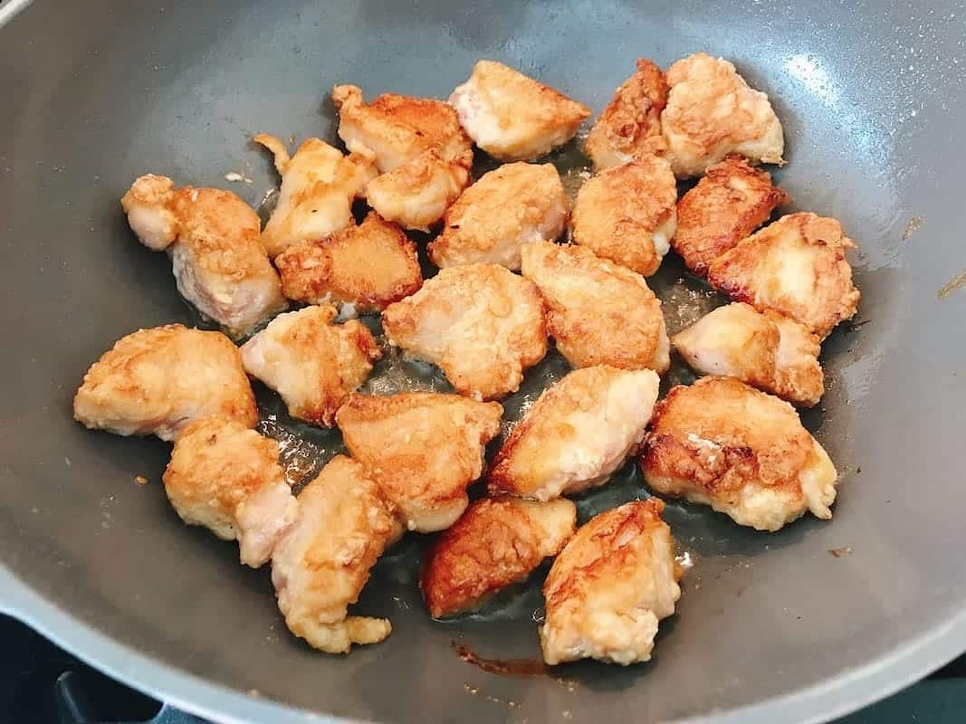 Add the chicken pieces one-by-one into the pan. Turn up the heat to medium-high. Pan fry the chicken in a single layer without disturbing for about 3 minutes on the first side. Then use a chopstick or tong to cook the flip side for about 2 minutes. Transfer them out to a separate plate.