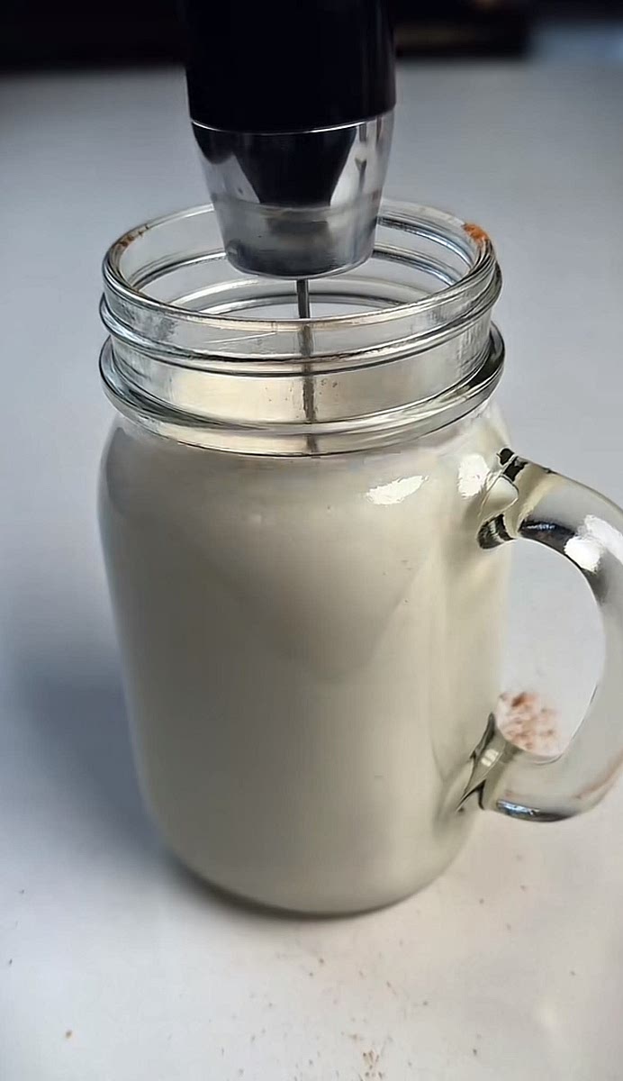 To a separate glass, add the vanilla, milk and cinnamon, then froth