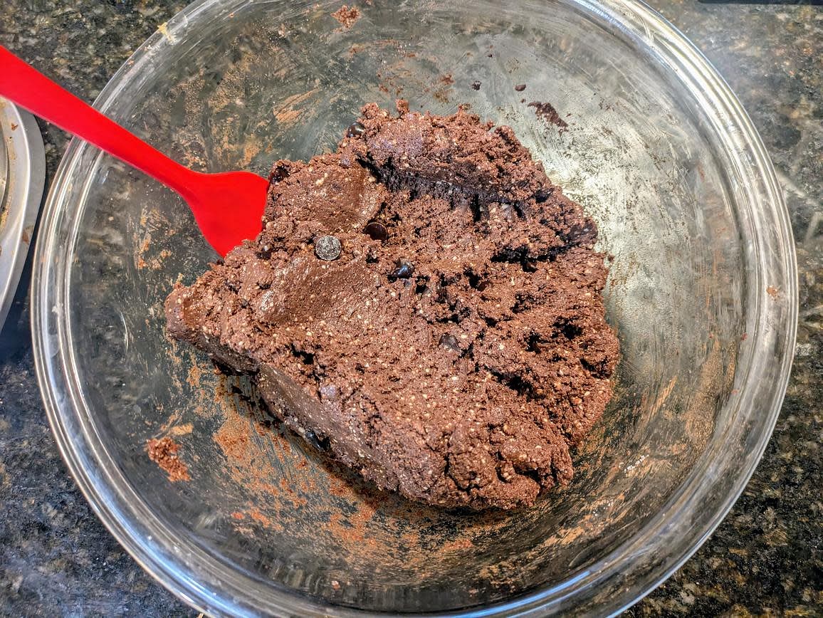 In a large bowl, combine together (whipped) cottage cheese, almond butter, cocoa powder, and granulated monk fruit with a silicone spatula. The "batter" will be very thick, like the texture of cookie dough. Fold in half the chocolate chips (1/4 cup, 45 g)