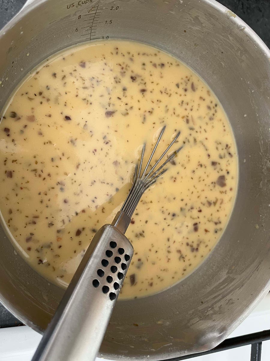 Whole the oven heat up, get the bowl with the batter out of the fridge. The gram flour would have set in the bottom. Mix the batter well with a whisk until you get a homogeneous mix.