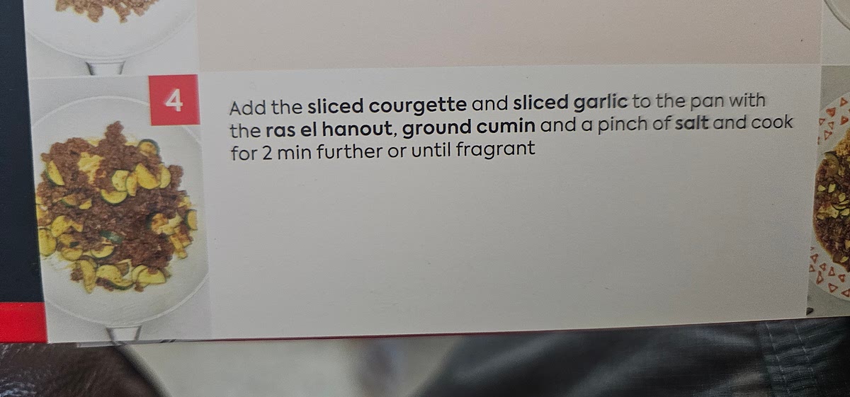 Add the sliced courgette, sliced garlic, ras el hangout, ground cumin and a pinch of salt