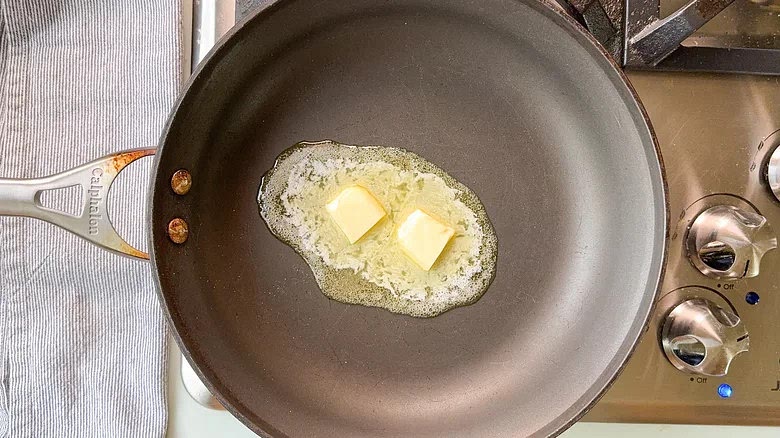 Melt the butter in a large, heavy skillet over medium heat.