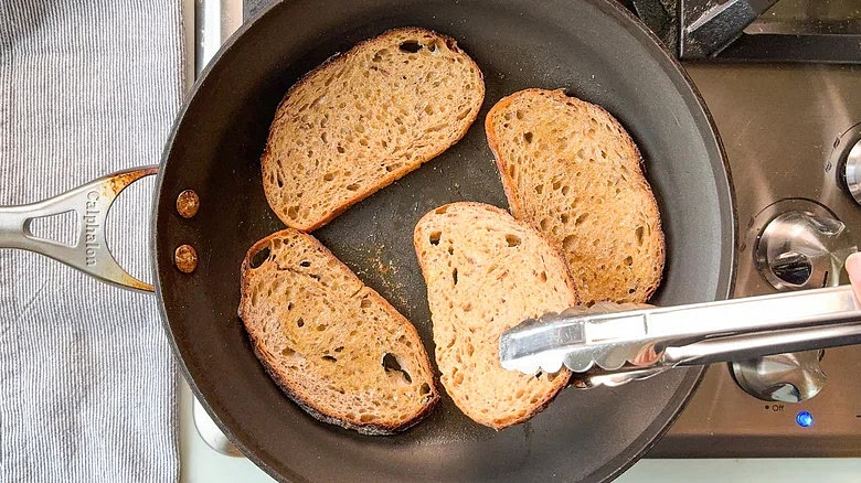 Turn the slices and cook on the other side until golden and toasted.