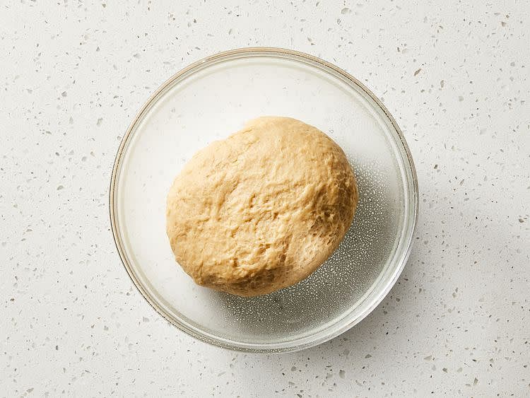 Turn dough out onto a floured surface and knead until smooth and elastic, 6 to 8 minutes. Place in a large greased bowl; turn dough to coat.