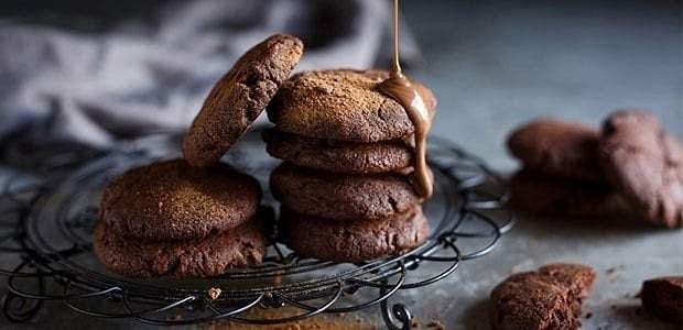 Instructions 1. Preheat the oven to 180°C (350°F) and line a baking tray with parchment paper. 2. Cream the butter and sugars together in a large bowl until light and fluffy. 3. Add the eggs and vanilla extract, beating well to combine. 4. Stir in the melted chocolate until fully incorporated. 5. In a separate bowl, whisk together the flour, cocoa powder, bicarbonate of soda, and salt. 6. Gradually add the dry ingredients to the wet mixture, mixing until just combined. 7. Fold in the chopped chocolate and Milo powder until evenly distributed. 8. Scoop tablespoon-sized amounts of dough onto the prepared baking tray, spacing them about 5cm apart. 9. Bake for 10–12 minutes, or until the edges are set and the centers are still soft. 10. Allow to cool on the tray for 5 minutes before transferring to a wire rack to cool completely.