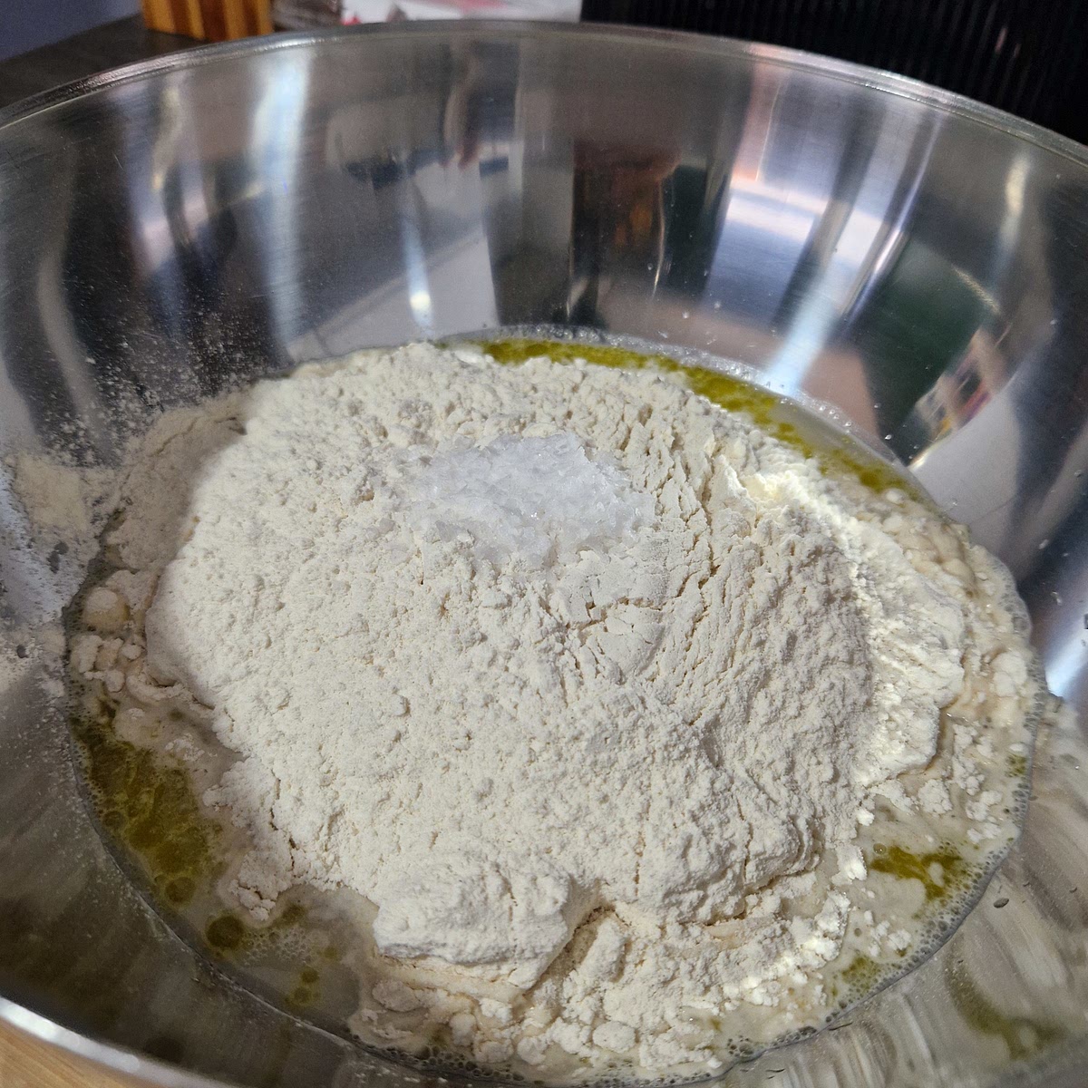Add in the (500g) strong white bread flour and (10g) fine sea salt