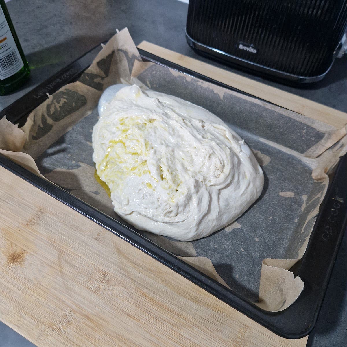 Pour out the bread dough onto the baking sheet.
