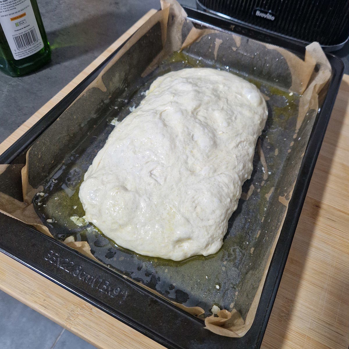 With oiled hands, fold the dough into a burrito-like shape and place length ways.