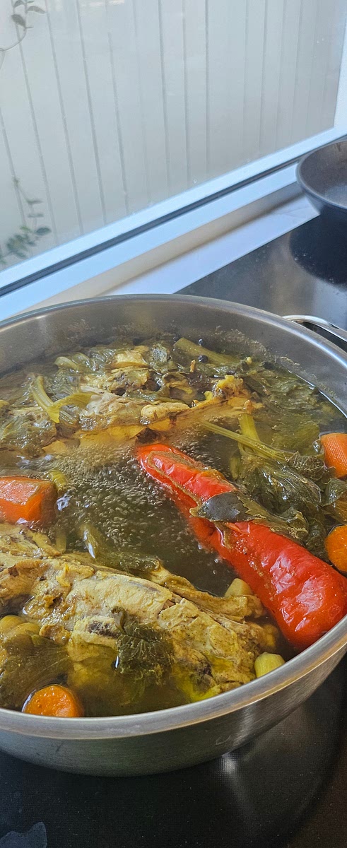 In a large stock pot add the whole chicken and all the other ingredients. Fill up with water until chicken and all vegetables are covered. Bring to the boil, then reduce to a simmer. Cover and simmer for 2 hours. Skim the froth off the top at least twice while it is simmering. Note that at thsi stage it may look unappetising, the colour will go a bit brown and yellow. That is from the tumeric and celery leaves. That is normal. The stock will be strained at the end of the cooking time.