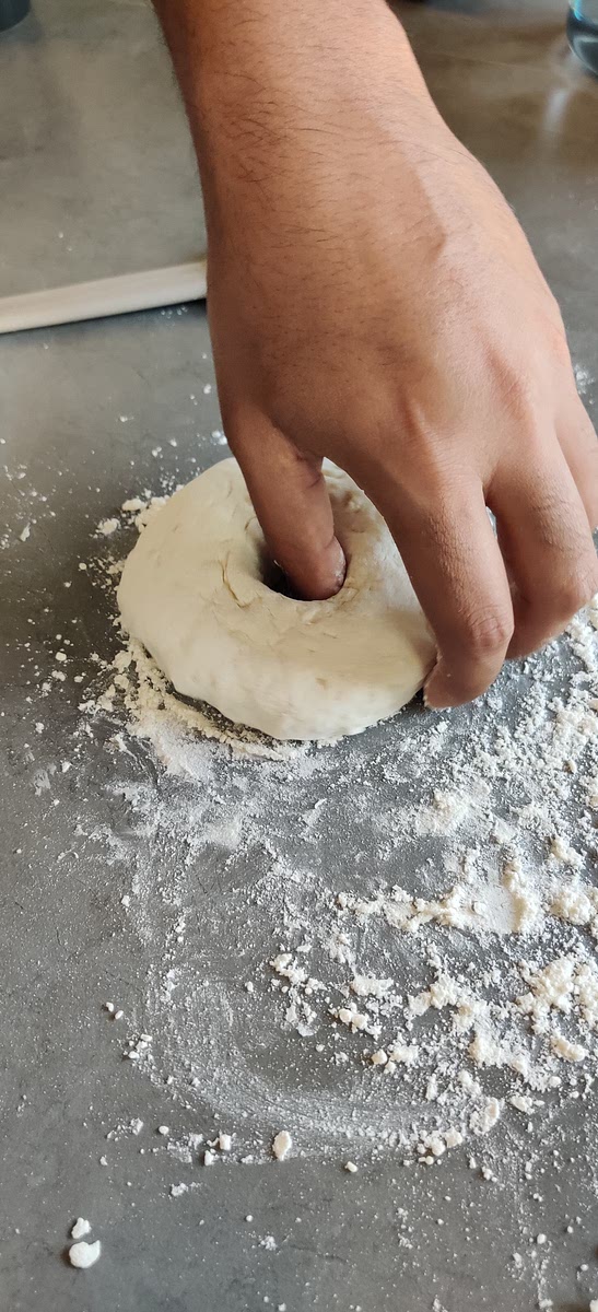 Then gently poke a hole in the center with your finger and shape it into a bagel ring.