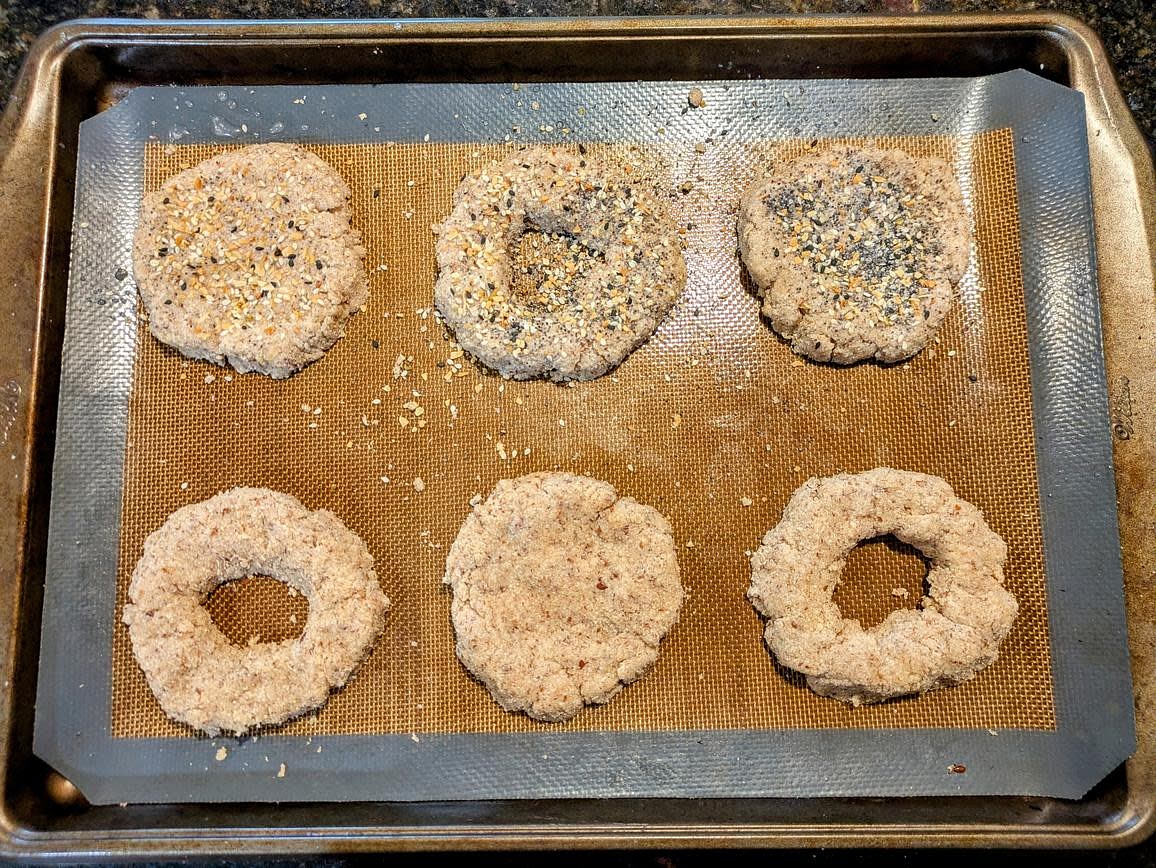 Roll each piece into balls, and flatten down. You can either make these into rolls, or carve out a hole in the center and make it a bagel. I'll be doing both here