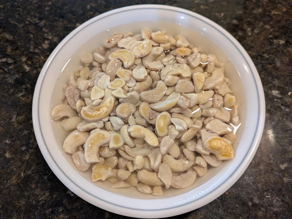 Add your cashews to a bowl, cover with water, and let soak for at least 2 hours. Reserve 1/2 cup (120 g) of the water, and discard the rest